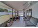 Enclosed patio boasts tiled flooring and comfortable seating at 135 Coral Dr, Safety Harbor, FL 34695