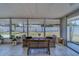 The enclosed porch contains table and chairs for relaxing at 135 Coral Dr, Safety Harbor, FL 34695