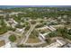 An aerial view of a property showing landscaping, roof lines and surrounding neighborhood with mature trees at 1472 Mission Hills Blvd # 24F, Clearwater, FL 33759