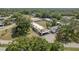Aerial view of well-maintained homes with carports surrounded by lush greenery and mature trees at 1472 Mission Hills Blvd # 24F, Clearwater, FL 33759