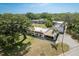 Expansive aerial view of a well-maintained single-story home, mature trees, and a private carport at 1472 Mission Hills Blvd # 24F, Clearwater, FL 33759