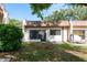 Backyard view of the townhome featuring a door leading to the patio, and green space at 1472 Mission Hills Blvd # 24F, Clearwater, FL 33759