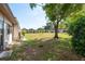 Backyard with a large grassy area and mature trees, perfect for outdoor activities at 1472 Mission Hills Blvd # 24F, Clearwater, FL 33759