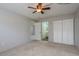 Carpeted bedroom with closet and an open doorway to an en-suite bathroom at 1472 Mission Hills Blvd # 24F, Clearwater, FL 33759