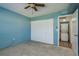 Carpeted bedroom with bi-fold closet and doorway to the laundry nook at 1472 Mission Hills Blvd # 24F, Clearwater, FL 33759
