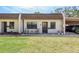 Charming single-story townhome with well-maintained lawn and cozy front seating area near covered parking at 1472 Mission Hills Blvd # 24F, Clearwater, FL 33759