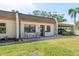 Inviting townhome exterior featuring neutral tones, a quaint seating area, and convenient carport access at 1472 Mission Hills Blvd # 24F, Clearwater, FL 33759
