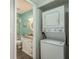 View of a stackable washer and dryer in a laundry nook near the bathroom at 1472 Mission Hills Blvd # 24F, Clearwater, FL 33759