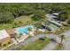 Inviting community pool area featuring lounge chairs, palm trees, and well-manicured landscaping at 1472 Mission Hills Blvd # 24F, Clearwater, FL 33759