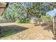 Large fenced backyard with mature trees providing shade and privacy at 16309 Caliente Pl, Tampa, FL 33624