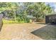 Large backyard featuring mature trees, foliage, and a screened-in patio at 16309 Caliente Pl, Tampa, FL 33624