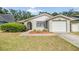 Charming single-story home with a well-manicured lawn and attached garage at 16309 Caliente Pl, Tampa, FL 33624