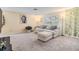 Cozy living room features comfortable seating, a large window, and serene artwork at 16309 Caliente Pl, Tampa, FL 33624