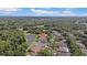 Aerial view of the neighborhood and a home situated by the pond with lush landscaping at 17124 Falconridge Rd, Lithia, FL 33547