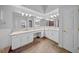 Bright bathroom features double sinks, granite counters, white cabinets, and tile floors at 17124 Falconridge Rd, Lithia, FL 33547