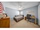Bedroom with a ceiling fan and a desk and chair and decorated with automotive themed art at 17124 Falconridge Rd, Lithia, FL 33547