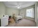 Bedroom with ceiling fan, bed with decorative pillows, desk, and dresser at 17124 Falconridge Rd, Lithia, FL 33547