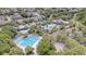 Aerial view of a community pool and clubhouse with lush landscaping and palm trees at 17124 Falconridge Rd, Lithia, FL 33547