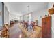 Open-concept dining room with hardwood floors flowing into the living area and abundant natural light at 17124 Falconridge Rd, Lithia, FL 33547