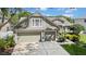 Two-story home featuring an attached three-car garage and well-maintained landscaping at 17124 Falconridge Rd, Lithia, FL 33547