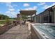 Outdoor hot tub beside a covered patio with view of the lake at 17124 Falconridge Rd, Lithia, FL 33547