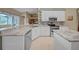 Modern kitchen with granite countertops, stainless steel appliances, and white cabinetry and a breakfast bar at 17124 Falconridge Rd, Lithia, FL 33547