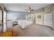 Spacious main bedroom with vaulted ceilings, ceiling fan, and large windows at 17124 Falconridge Rd, Lithia, FL 33547