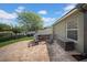 Brick patio with an outdoor seating area next to the backyard, landscaping, and pond at 17124 Falconridge Rd, Lithia, FL 33547