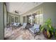 Inviting covered patio with comfortable seating and a ceiling fan, perfect for outdoor entertaining at 17124 Falconridge Rd, Lithia, FL 33547