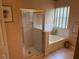 Bathroom featuring a soaking tub and glass shower doors at 1765 Oak Pond Ct, Oldsmar, FL 34677