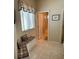 Bathroom shows tile flooring and a built-in bench seating area near the window at 1765 Oak Pond Ct, Oldsmar, FL 34677