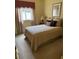 Bedroom featuring plush carpeting, a soft bed, and ample natural light from a window at 1765 Oak Pond Ct, Oldsmar, FL 34677