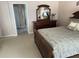 Bedroom featuring coordinated furniture, plush bedding, and an ensuite bathroom at 1765 Oak Pond Ct, Oldsmar, FL 34677