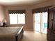 Bedroom offering natural light, closet, and a sliding door to an outdoor area at 1765 Oak Pond Ct, Oldsmar, FL 34677