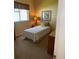 Bedroom showing a twin bed with floral accents and a window allowing natural light at 1765 Oak Pond Ct, Oldsmar, FL 34677