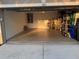 Spacious garage showcases ample room for parking and storage on shelves at 1765 Oak Pond Ct, Oldsmar, FL 34677