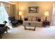 Elegant living room with plush seating, glass coffee table, and abundant natural light at 1765 Oak Pond Ct, Oldsmar, FL 34677
