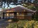 Exterior view of the community pool gate showcasing the tile roof and welcoming landscaping at 1765 Oak Pond Ct, Oldsmar, FL 34677