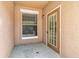 A small entryway featuring a glass-paneled front door and a window with blinds at 18017 Villa Creek Dr # 18017, Tampa, FL 33647