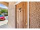 A close-up of a brown front door with gold hardware, unit number 18017, and textured stucco wall at 18017 Villa Creek Dr # 18017, Tampa, FL 33647