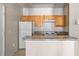 Kitchen with white refrigerator and wood cabinets at 18017 Villa Creek Dr # 18017, Tampa, FL 33647