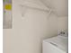 Laundry room with mounted wire shelving and white washing machine at 18017 Villa Creek Dr # 18017, Tampa, FL 33647