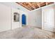 Living room needing repair, featuring exposed ceiling beams, windows, a doorway and damaged walls and floor at 18017 Villa Creek Dr # 18017, Tampa, FL 33647