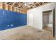 Open living room, showing doorway to bathroom and adjacent bright blue wall at 18017 Villa Creek Dr # 18017, Tampa, FL 33647