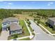 An aerial view of the home's location, near a scenic greenbelt with a pond at 18219 Ramble On Way, Land O Lakes, FL 34638