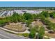 Aerial view of the area showcasing a school and recreation area surrounded by trees and community developments at 18219 Ramble On Way, Land O Lakes, FL 34638