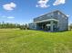 A spacious backyard that highlights the outdoor living space, seamlessly blending with a large grassy lawn at 18219 Ramble On Way, Land O Lakes, FL 34638