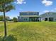 A large backyard lawn leading up to a home's patio that is great for outdoor living at 18219 Ramble On Way, Land O Lakes, FL 34638