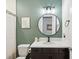 Bathroom with a round mirror, modern vanity, and a shower with a patterned curtain at 18219 Ramble On Way, Land O Lakes, FL 34638