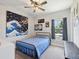 Comfortable bedroom with a striking celestial theme, featuring a metal bed frame and ample natural light at 18219 Ramble On Way, Land O Lakes, FL 34638